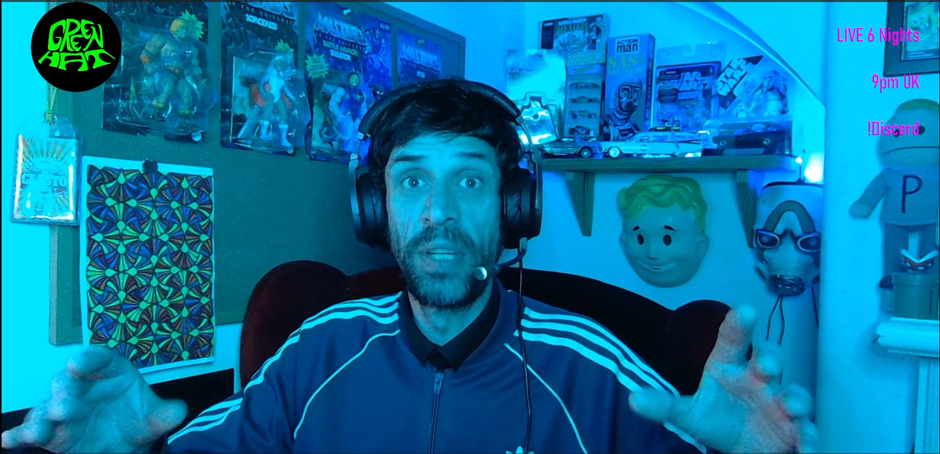 GreenUnderScoreHat streaming in a blue-lit gaming room